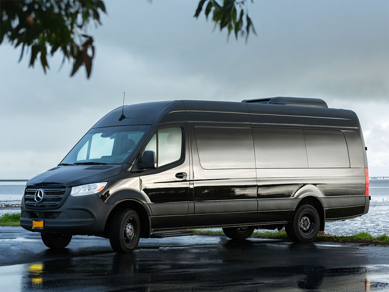 Mercedes-Benz Sprinter tour van parked by the water